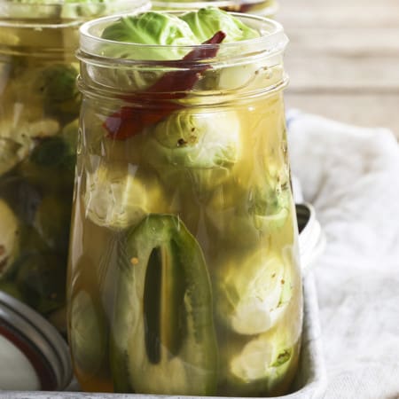 Pickled Brussels Sprouts are garlicky, tangy, crisp-tender, pickled orbs that are delicious as a snack or on a charcuterie board.