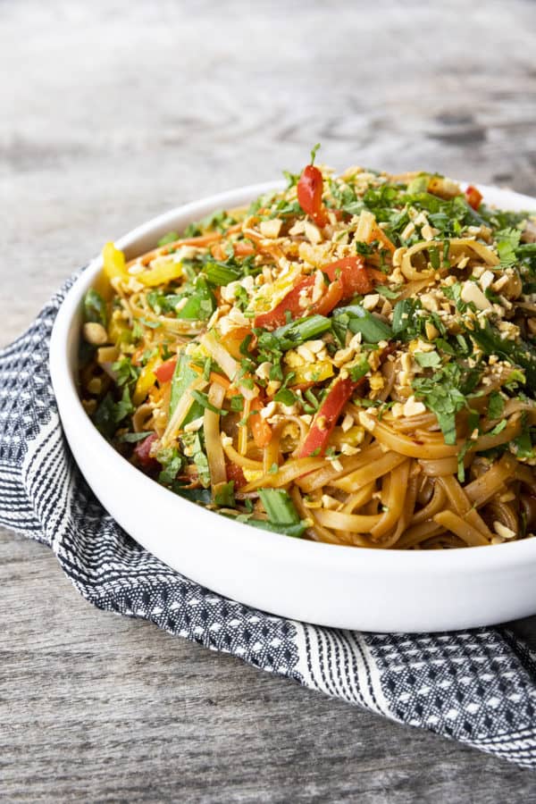 Chewy rice noodles scandalously loaded with crisp tender vegetables, a flavourful garlic and ginger sauce, and eggs make up our divine Rice Noodle Stir Fry.