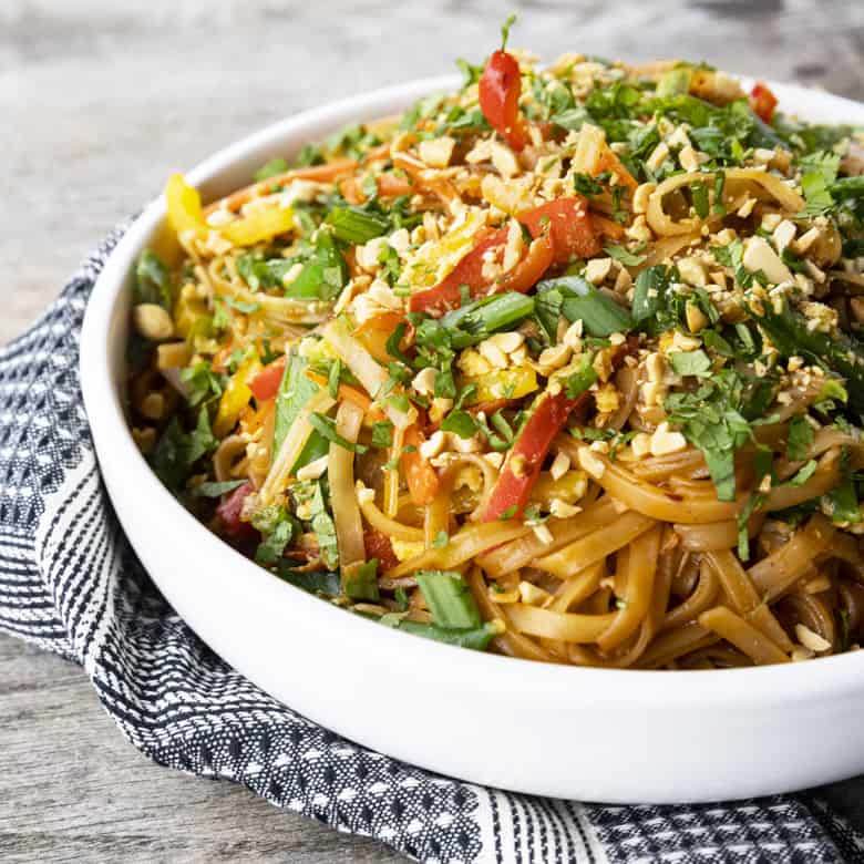 Chewy rice noodles scandalously loaded with crisp tender vegetables, a flavourful garlic and ginger sauce, and eggs make up our divine Rice Noodle Stir Fry.