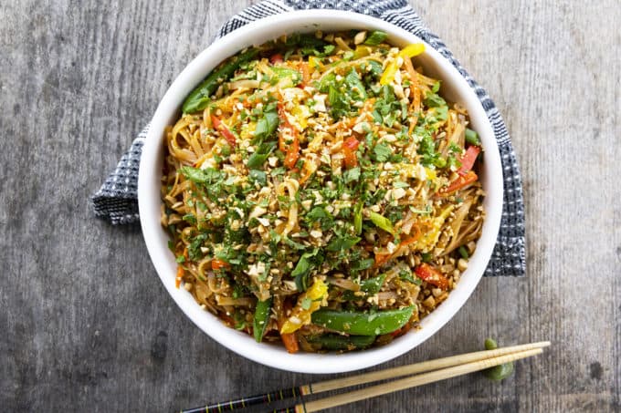 Chewy rice noodles scandalously loaded with crisp tender vegetables, a flavourful garlic and ginger sauce, and eggs make up our divine Rice Noodle Stir Fry.