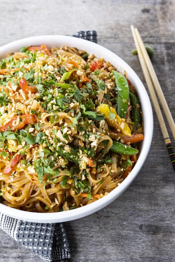 Chewy rice noodles scandalously loaded with crisp tender vegetables, a flavourful garlic and ginger sauce, and eggs make up our divine Rice Noodle Stir Fry.