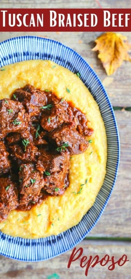 Tuscan Braised Beef in red wine sauce on creamy polenta in a blue and white dish.