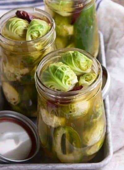 Pickled Brussels Sprouts are garlicky, tangy, crisp-tender, pickled orbs that are delicious as a snack or on a charcuterie board.