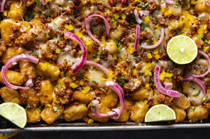 Change up Nacho Night by serving crave-ably good Tater Tot Nachos a.k.a. Totchos. These irresistible crispy baked tots are topped with spicy Chorizo, gooey melted Cheddar, pickled onions, and other nacho goodies!