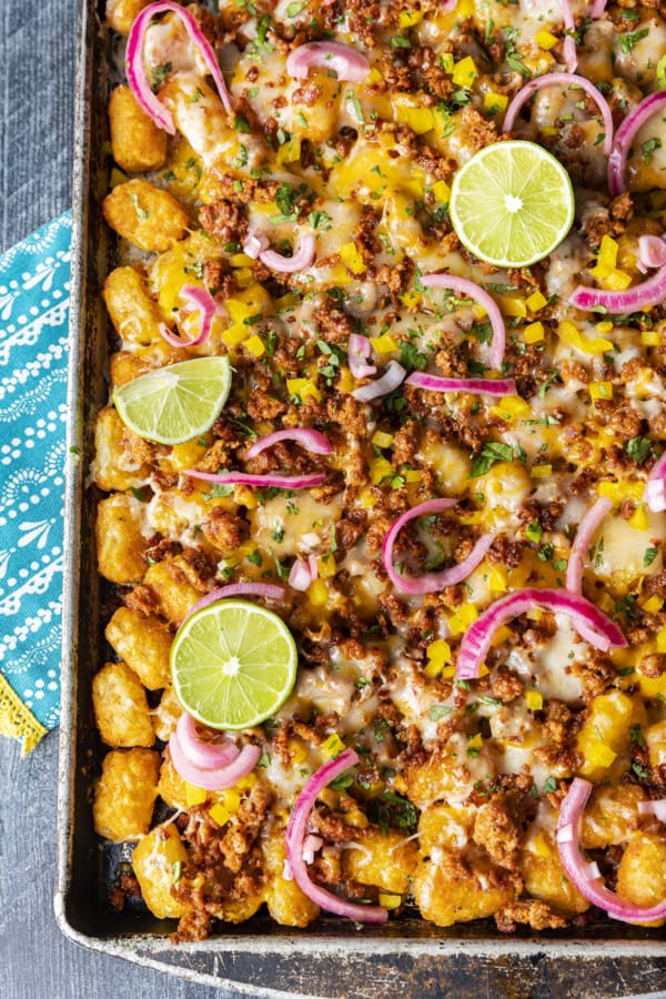 Change up Nacho Night by serving crave-ably good Tater Tot Nachos a.k.a. Totchos. These irresistible crispy baked tots are topped with spicy Chorizo, gooey melted Cheddar, pickled onions, and other nacho goodies!