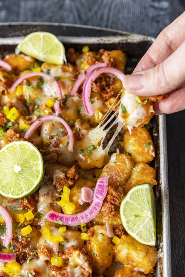 Change up Nacho Night by serving Tater Tot Nachos a.k.a. Totchos with Chorizo, Cheddar, green onions, and other nacho goodies!
