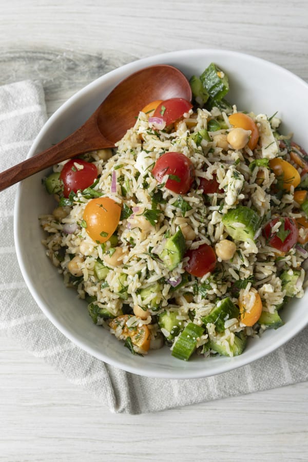 This delightful chilled Grain Salad is chock full of nutty brown rice, herbs, garbanzo beans, cucumbers, tomatoes, feta cheese, and red onions with a simple olive oil and lemon juice dressing. Make a batch of this to stash in the fridge and lunch is in the bag all week!