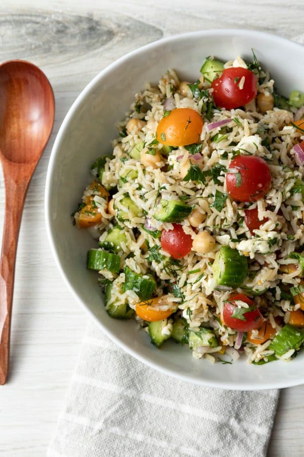 This delightful chilled Grain Salad is chock full of nutty brown rice, herbs, garbanzo beans, cucumbers, tomatoes, feta cheese, and red onions with a simple olive oil and lemon juice dressing. Make a batch of this to stash in the fridge and lunch is in the bag all week!