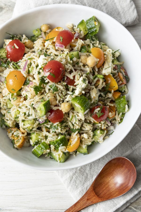 This delightful chilled Grain Salad is chock full of nutty brown rice, herbs, garbanzo beans, cucumbers, tomatoes, feta cheese, and red onions with a simple olive oil and lemon juice dressing. Make a batch of this to stash in the fridge and lunch is in the bag all week!