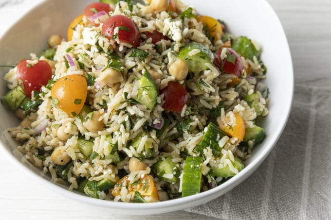 This delightful chilled Grain Salad is chock full of nutty brown rice, herbs, garbanzo beans, cucumbers, tomatoes, feta cheese, and red onions with a simple olive oil and lemon juice dressing. Make a batch of this to stash in the fridge and lunch is in the bag all week!