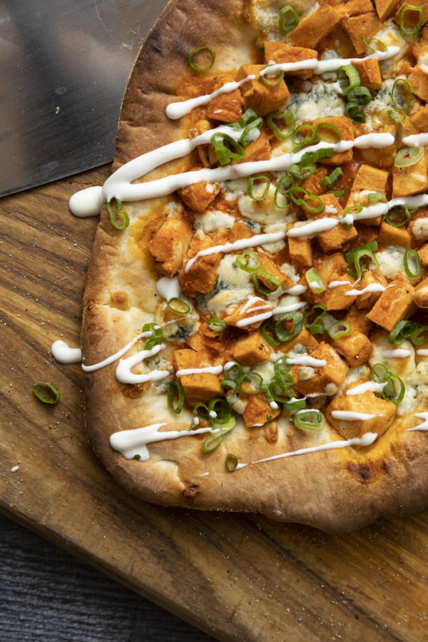 Tender cubes of Spicy Buffalo chicken, blue cheese crumbles or another cheese of your choice, thinly sliced green onions, and a drizzle of blue cheese dressing or ranch dressing top flatbread proving that great food doesn't have to be complicated! Buffalo Chicken Flatbread is equally fabulous as a great appetizer for game day or as an easy dinner.