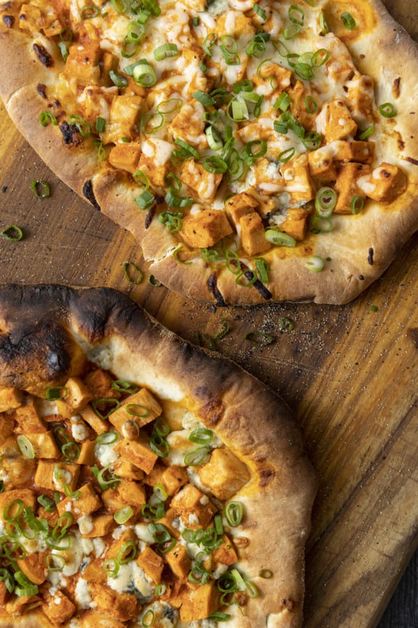 Tender cubes of Spicy Buffalo chicken, blue cheese crumbles or another cheese of your choice, thinly sliced green onions, and a drizzle of blue cheese dressing or ranch dressing top flatbread proving that great food doesn't have to be complicated! Buffalo Chicken Flatbread is equally fabulous as a great appetizer for game day or as an easy dinner.