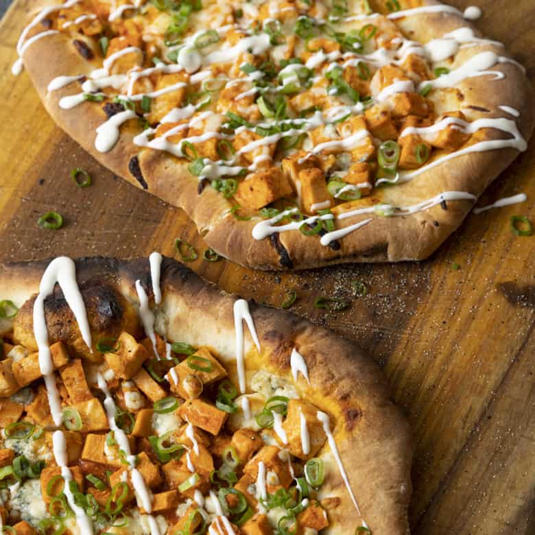 Tender cubes of Spicy Buffalo chicken, blue cheese crumbles or another cheese of your choice, thinly sliced green onions, and a drizzle of blue cheese dressing or ranch dressing top flatbread proving that great food doesn't have to be complicated! Buffalo Chicken Flatbread is equally fabulous as a great appetizer for game day or as an easy dinner.