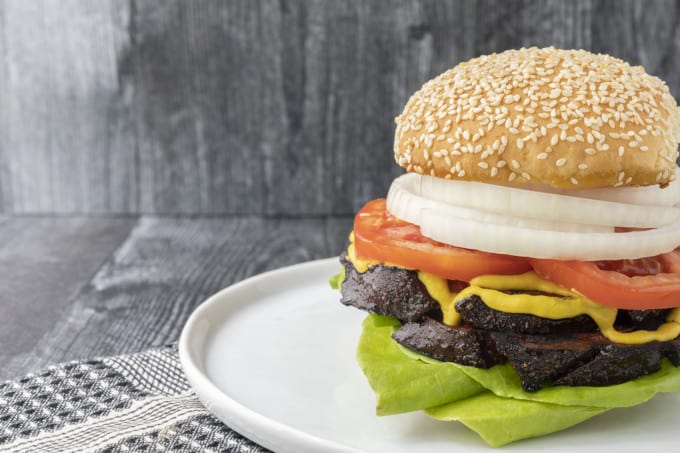 crispy-edged bologna on a hamburger bun or great homemade sandwich bread with mustard or mayo, lettuce, tomato, and a slab of sweet onion.