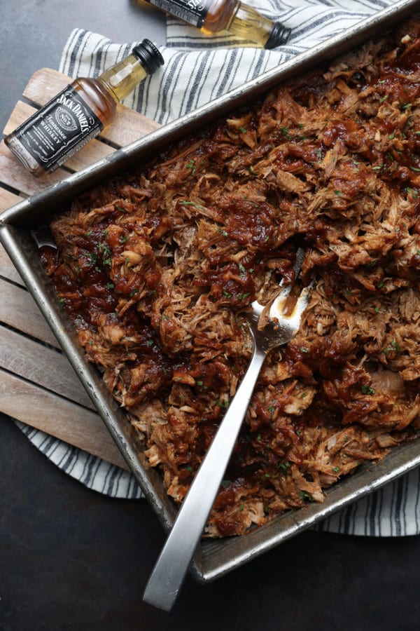 Today’s slow cooker recipe for Jack Daniels Pulled Pork is my go-to; it’s a reliable, easy recipe for the best pulled pork ever. Budget-friendly succulent pork shoulder slow cooks in Jack Daniels forming an irresistible whiskey bbq sauce. I mean honestly. How could this be anything less than sublime?