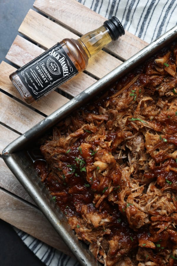 Today’s slow cooker recipe for Jack Daniels Pulled Pork is my go-to; it’s a reliable, easy recipe for the best pulled pork ever. Budget-friendly succulent pork shoulder slow cooks in Jack Daniels forming an irresistible whiskey bbq sauce. I mean honestly. How could this be anything less than sublime?