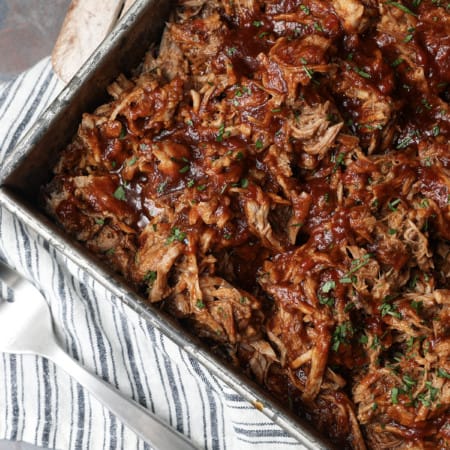 Today’s slow cooker recipe for Jack Daniels Pulled Pork is my go-to; it’s a reliable, easy recipe for the best pulled pork ever. Budget-friendly succulent pork shoulder slow cooks in Jack Daniels forming an irresistible whiskey bbq sauce. I mean honestly. How could this be anything less than sublime?