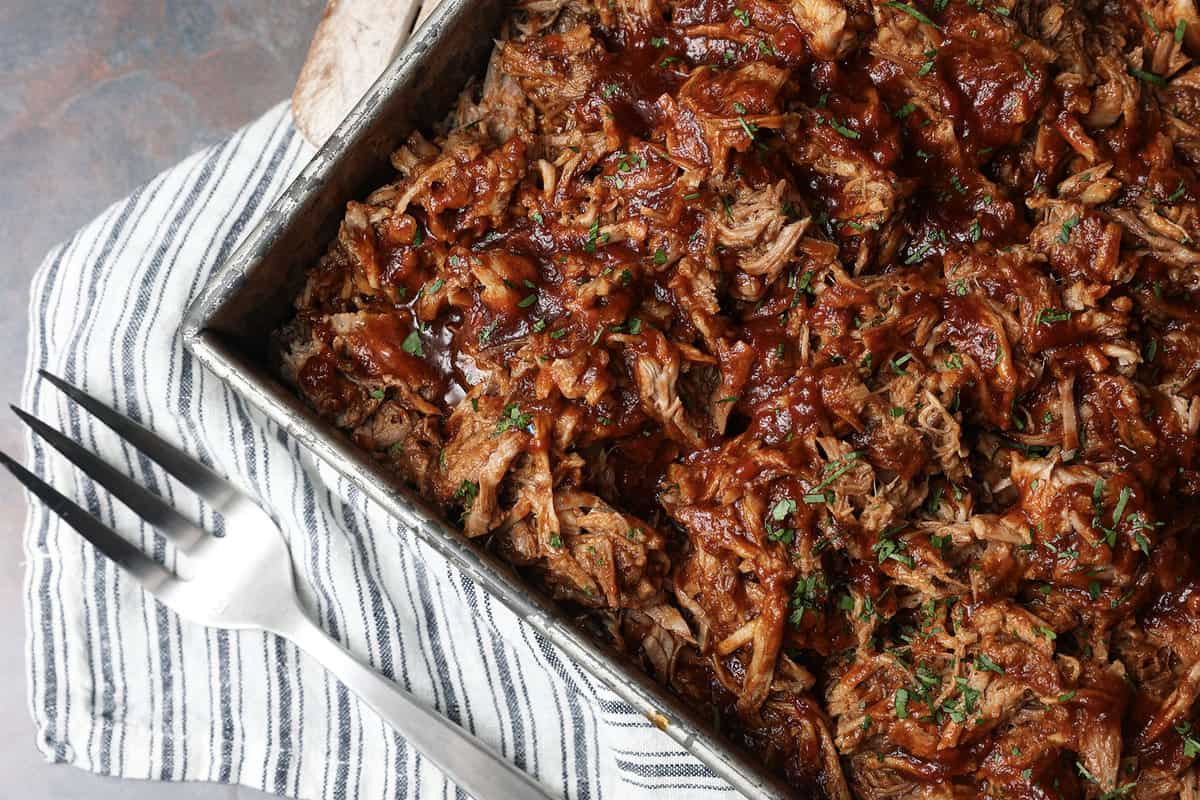 Today’s slow cooker recipe for Jack Daniels Pulled Pork is my go-to; it’s a reliable, easy recipe for the best pulled pork ever. Budget-friendly succulent pork shoulder slow cooks in Jack Daniels forming an irresistible whiskey bbq sauce. I mean honestly. How could this be anything less than sublime?