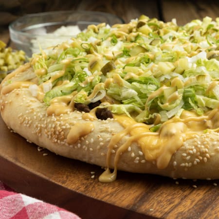 Big Mac Pizza brings the classic “two all beef patties, special sauce, lettuce, cheese, pickles, onions, on a sesame seed bun” taste that you love to pizza in this irresistible recipe! It’s got that craveable fast-food flavour but made fresher than the real thing in your own home for pizza night.