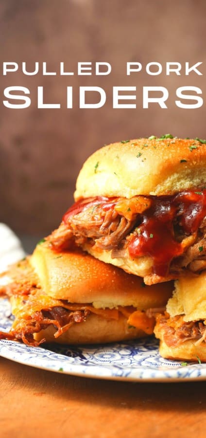 Easy Pulled Pork Sliders: Pillowy rolls filled with delicious, mouth-watering, tender pulled pork, bbq sauce, and cheese are brushed with melted butter, garlic, and herbs, then baked to toasty, melty perfection. They’re like the little black dress of the sandwich world and perfect for every occasion. Bonus: They're done in 30 minutes from start to finish!