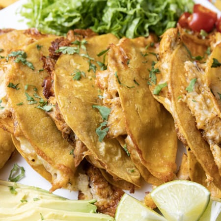 Ridiculously easy Crispy Chicken Tacos are the best of tacos, taquitos, and nachos combined! Flavourful shredded chicken and scandalous amounts of melted cheese are baked in corn tortillas until crispy, crunchy and altogether irresistible! This is bound to be your new favourite for busy weeknight meals, friends.