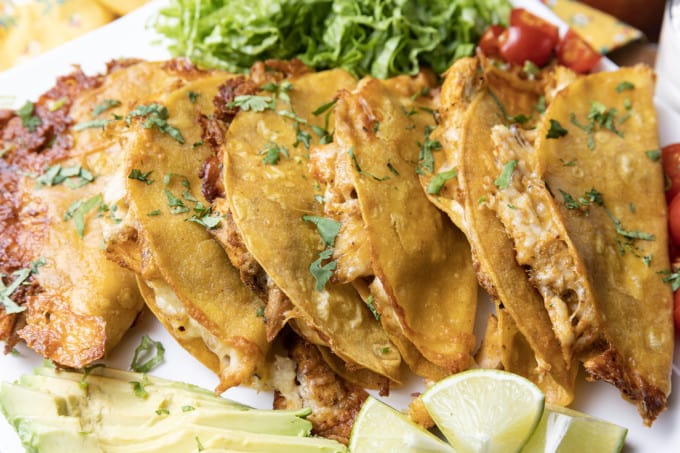 Ridiculously easy Crispy Chicken Tacos are the best of tacos, taquitos, and nachos combined! Flavourful shredded chicken and scandalous amounts of melted cheese are baked in corn tortillas until crispy, crunchy and altogether irresistible! This is bound to be your new favourite for busy weeknight meals, friends.