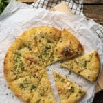 With its blistered, crispy crust and utterly irresistible aroma, Garlic Pizza is proof that the simplest things are often the best. You’ll find yourself turning to this deeply browned, super savoury pizza -made from simple ingredients that you likely have on hand already- more often than you can imagine. Garlic pizza is perfection in its simplicity. It’s just pizza dough brushed with homemade garlic oil, sprinkled with parmesan cheese, and a pinch of red pepper flakes.
