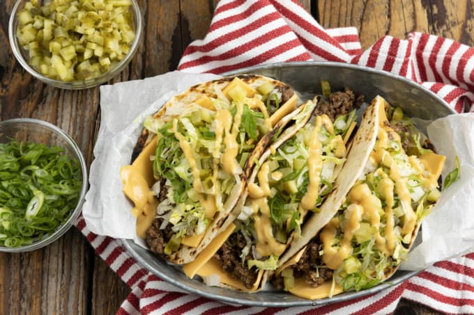 Big Mac Tacos: bringing “the golden arches” to taco night with irresistible tacos filled with seasoned beef, special sauce, lettuce, cheese, pickles, and onions on a sesame seed… tortilla. It’s everything you love about Big Macs in taco form and you don’t even have to leave the house to indulge!