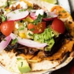 This crispy mushroom taco recipe with the works is for all my obsessive mushroom loving friends. It’s unapologetically mushroom forward, so this is not for you if you’re not into fungi. It’s almost laughably easy to make this substantial meatless taco recipe. Roasting the seasoned mushrooms on a metal sheet pan in a hot oven gives them delectable crispy edges.