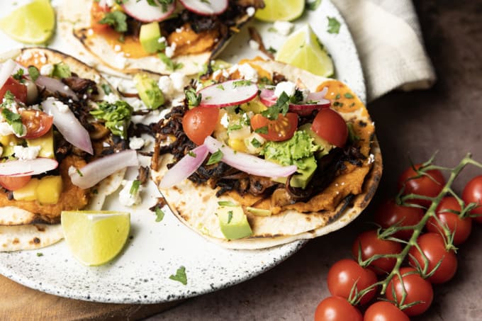 This crispy mushroom taco recipe with the works is for all my obsessive mushroom loving friends. It’s unapologetically mushroom forward, so this is not for you if you’re not into fungi. It’s almost laughably easy to make this substantial meatless taco recipe. Roasting the seasoned mushrooms on a metal sheet pan in a hot oven gives them delectable crispy edges.