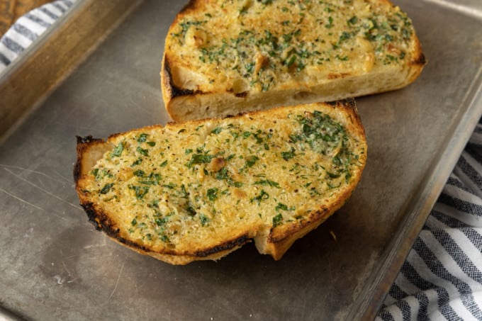 There are very few meals that are not immeasurably improved by a crusty garlic bread spread lavishly with melted butter, studded with roasted garlic, and carpeted with abundant fresh herbs. Time is often short, though, so keep a batch of this heavenly, fragrant garlic spread for bread on hand to make short work of big flavour.