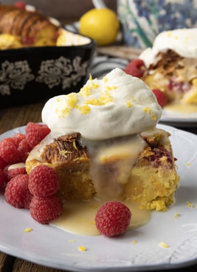 Rich, buttery, & indulgent, this creamy lemon and raspberry croissant bread pudding recipe is almost unbelievably easy to make. The flaky, layered croissant top gives way to the silky, vanilla and lemon scented custard that is studded with fresh raspberries. Optional cream cheese dotted through the custard makes this extraordinary decadent bread pudding taste a little like a cheesecake. It takes so few minutes of hands-on time to make any breakfast, brunch, or dessert a memorable occasion.