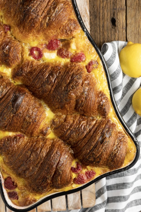 Rich, buttery, & indulgent, this creamy lemon and raspberry croissant bread pudding recipe is almost unbelievably easy to make. The flaky, layered croissant top gives way to the silky, vanilla and lemon scented custard that is studded with fresh raspberries. Optional cream cheese dotted through the custard makes this extraordinary decadent bread pudding taste a little like a cheesecake. It takes so few minutes of hands-on time to make any breakfast, brunch, or dessert a memorable occasion.