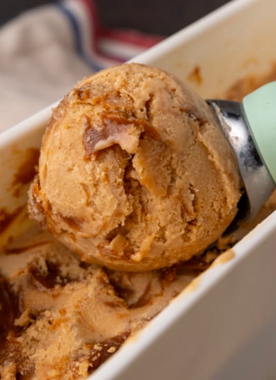 A scoop of ice cream is being scooped into a bowl.