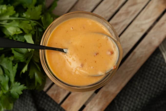 bang bang sauce in a jar with a spoon