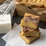 snickerdoodle cookie bars with a glass jar of milk