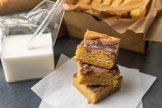 snickerdoodle cookie bars with a glass jar of milk 