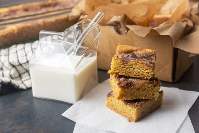 snickerdoodle cookie bars with a glass jar of milk