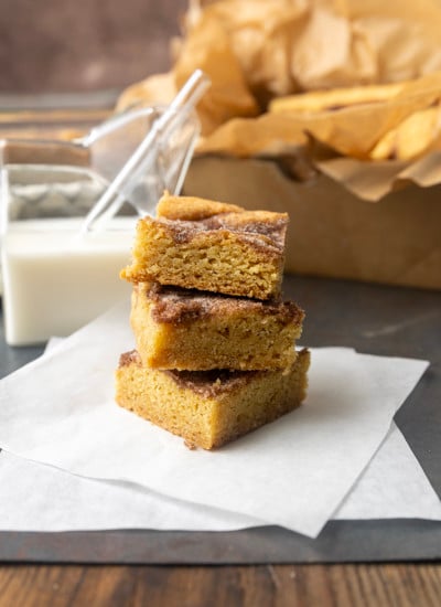 snickerdoodle cookie bars with a glass jar of milk
