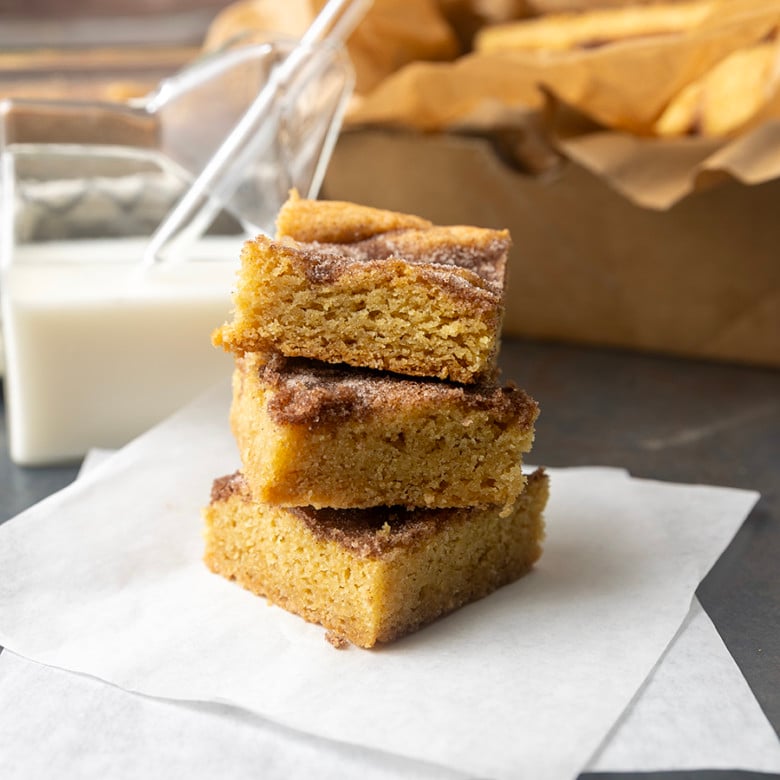 snickerdoodle cookie bars with a glass jar of milk