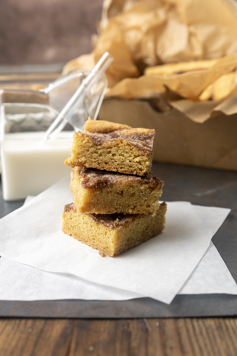 snickerdoodle cookie bars with a glass jar of milk