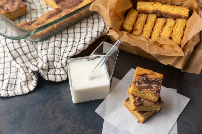 snickerdoodle cookie bars with a glass jar of milk