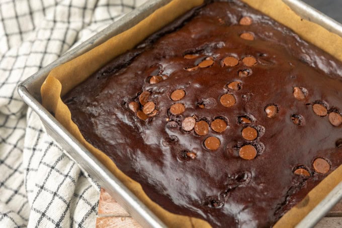 Greek yogurt brownies eggless brownies in a pan lined with parchment