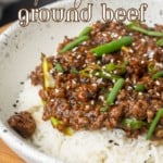 mongolian ground beef on rice in a bowl with text overlay describing the dish