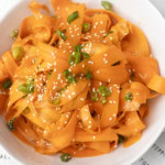 carrot ribbon salad in a white bowl