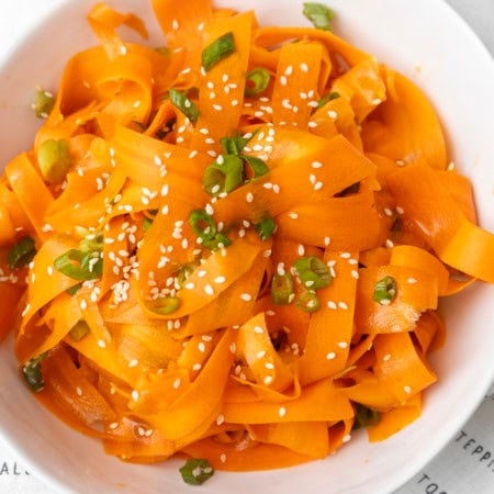 carrot ribbon salad in a white bowl