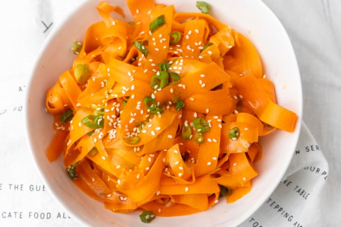 carrot ribbon salad in a white bowl