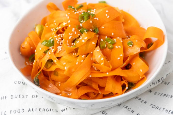 carrot ribbon salad in a white bowl