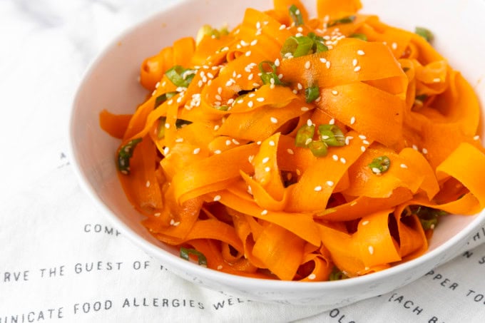 carrot ribbon salad in a white bowl