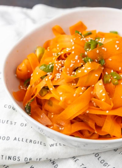 carrot ribbon salad in a white bowl